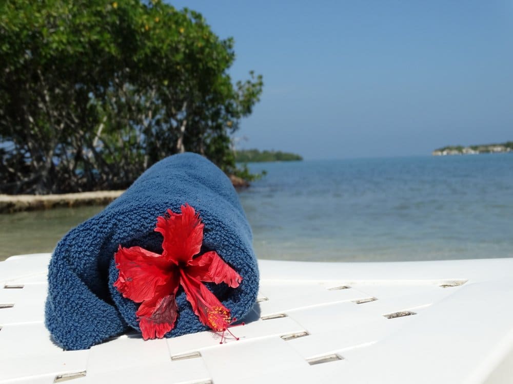 Blue towel with red flower at the beach of Rosario islands