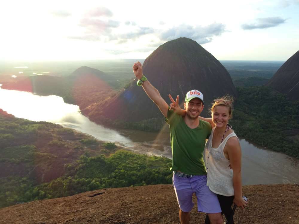 Two tourists in cerro de mavecure and a sunset