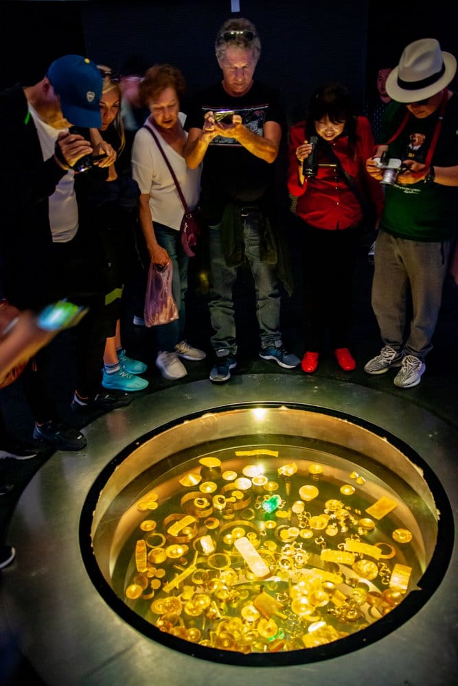Tourists seeing gold pieces in Gold Museum of Bogota