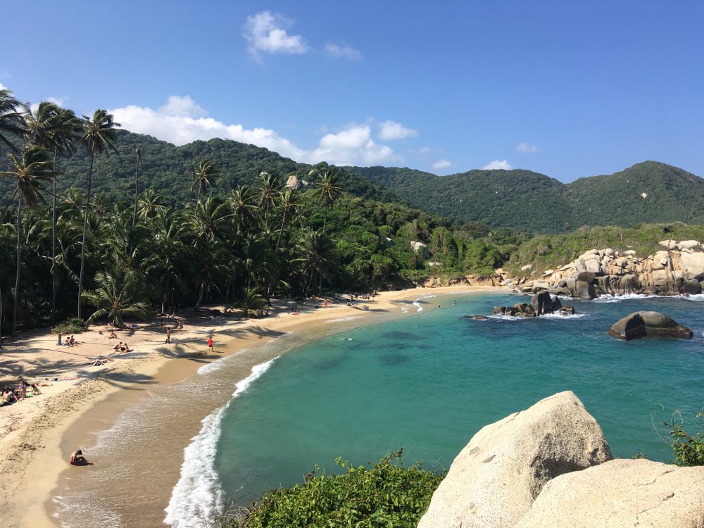 Tourists relaxing on beach of Cabo San Juan in Tayrona