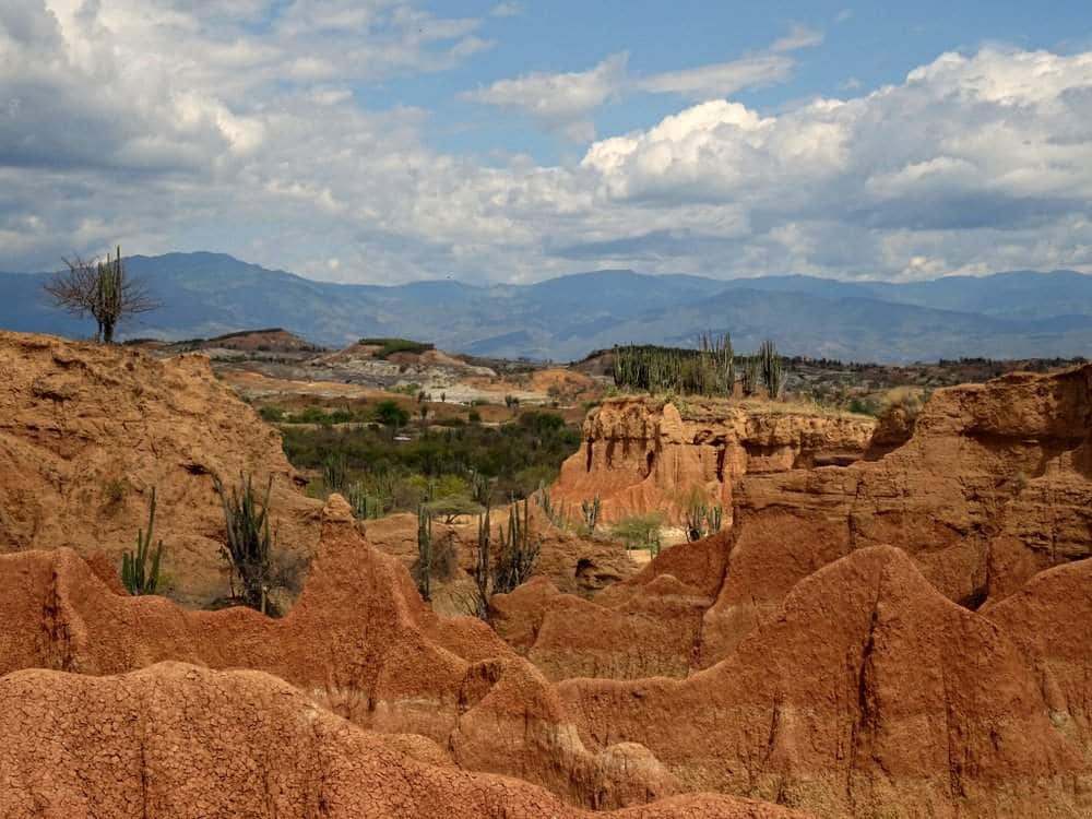 Reddish part of Tatacoa desert with mountains in background