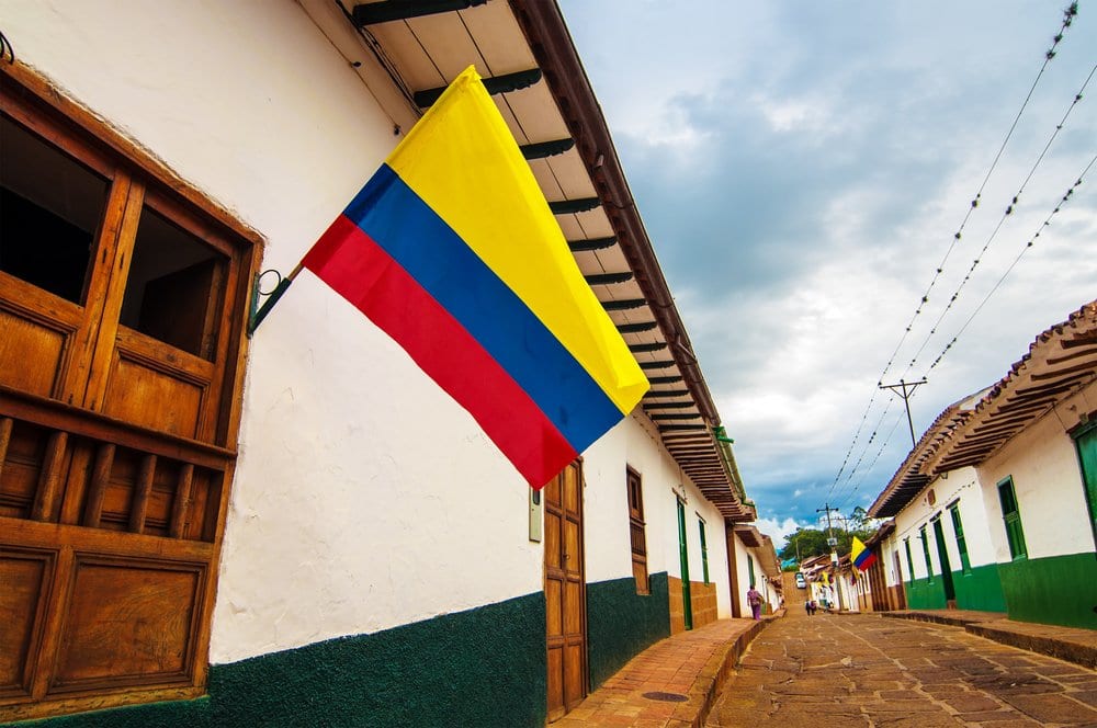Colonial street in Bogota with Colombian flag