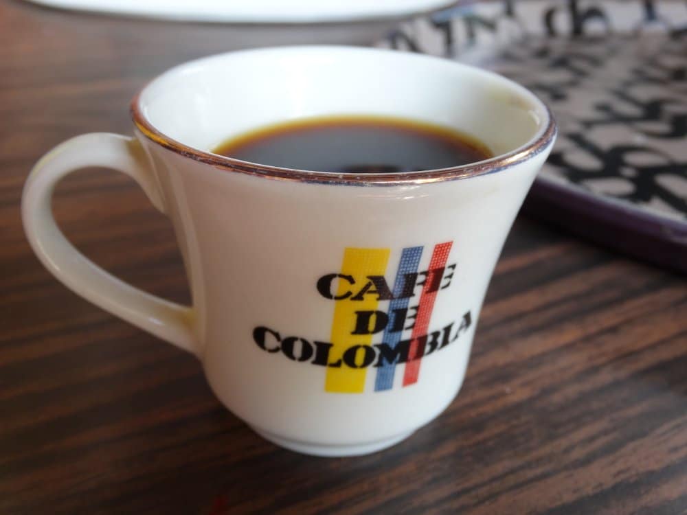Cup of coffee with Cafe de Colombia logo
