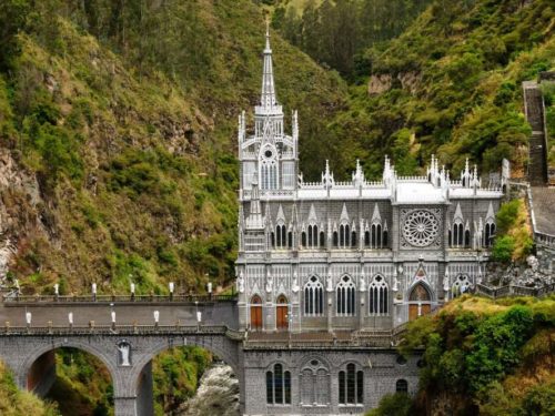 Side view of Las Lajas Sanctuary with bridge and green